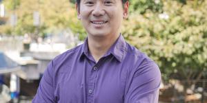 Photo of a man in a purple shirt