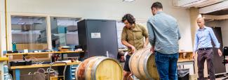 Barrelwise team moving wine barrels for testing at the HATCH Makerspace