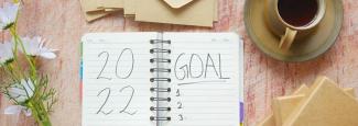 A journal open with "2022 Goal" written inside